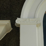 Ionic capital and crown moulding detail.